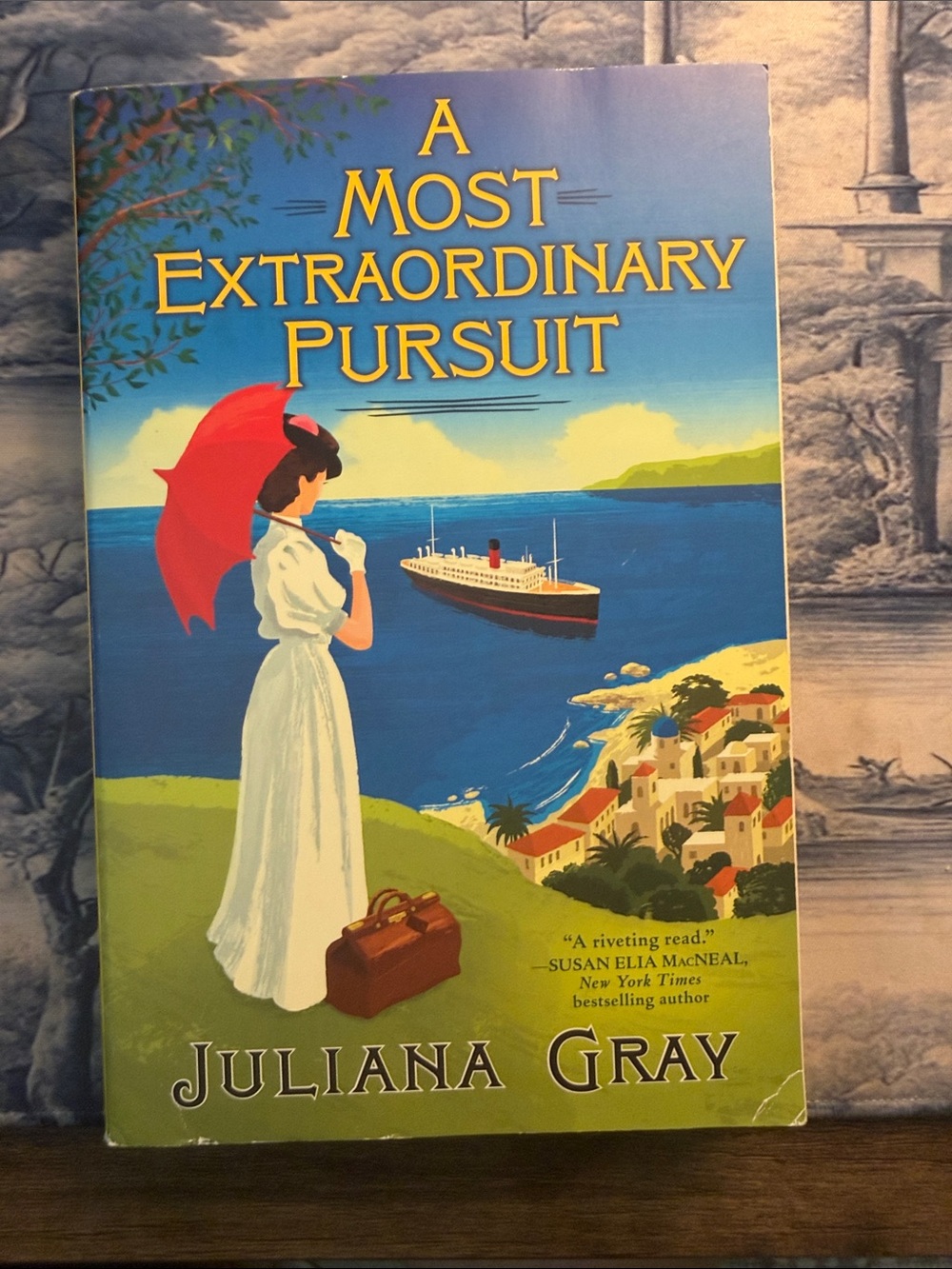 A Most Extraordinary Pursuit by — Blue and Red Cover Paperback
